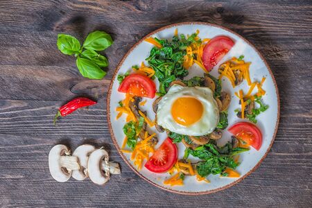 Spinach mushroom egg chilly basilico wooden deskの写真素材