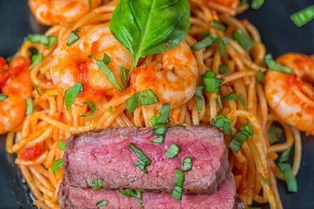 Spaghetti surf and turf basil close-upの写真素材