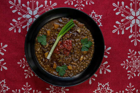 Lentil soup ingredients before cooking onion black plateの写真素材