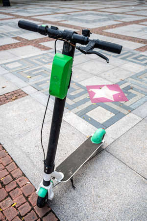 Electric scooter on a city square foggy dayの写真素材