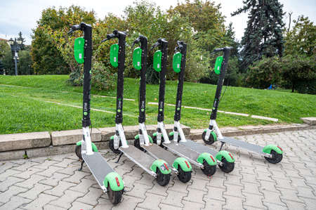 Electric scooters Lime S on a city square foggy dayのeditorial素材
