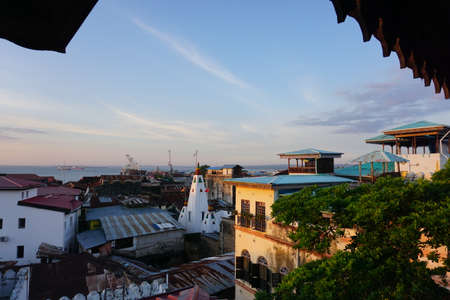 View onto the old town of Stone Town, Zanzibar at sunset, Tanzania 2021, with the princess salme museum on the right and the Shiv Shakti Temple in the middleのeditorial素材