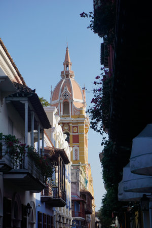 A street in downtown Cartagena with the belltower of the Cartagena Cathedral, Catedral de Santa Catalina de Alejandria, Colombia 2020の写真素材