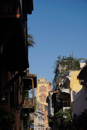 Street in Cartagena with the Cloister of St. Augustine campus bell tower in the background, Colombia 2020の写真素材