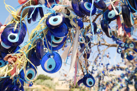 Close up on the blue glass eyes hanging from the evil eye tree next to the Pigeon Valley, Gの写真素材