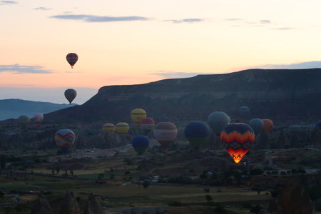 Hot air balloons rising from the balloon take off point next to Rose Valley, Red Valley in the early morning, close to Gの写真素材