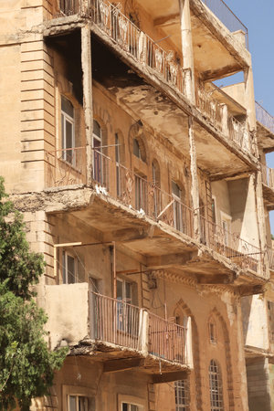 Elaborate traditional facade with many balconies on an apartment building in the old town of Mardin, Turkey 2022の写真素材