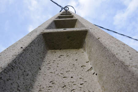 view of a concrete telephone cable poleの写真素材