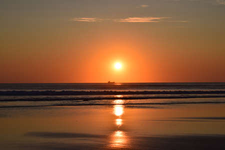 view of a sunset on the beach of Salinas, Asturias, Spainの写真素材