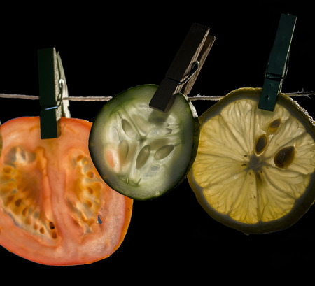Fresh food: slices of lemon, cucumber and tomatoの写真素材