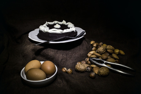 Sacher cakes, eggs and dried fruit photographed with the light painting techniqueの写真素材