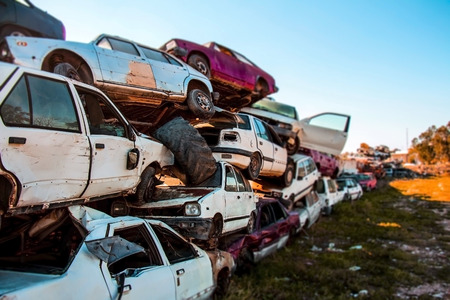 Pile of discarded cars on junkyardの写真素材