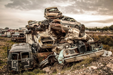 Pile of discarded cars on junkyardの写真素材