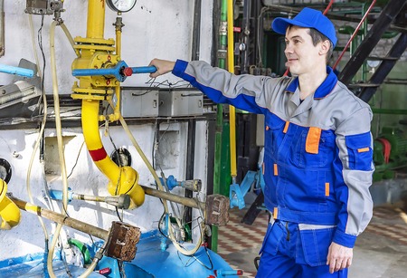 An experienced operator service gas boiler equipment.
