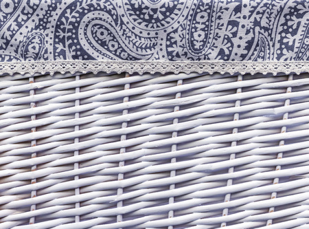 Background from a white wicker basket with fabric decoration.