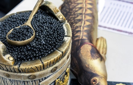 Black caviar in a barrel with a spoon.の写真素材