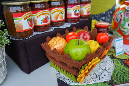 Basket with different fruits in the street shop of jam, compotes and jams.のeditorial素材