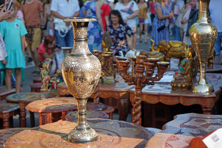 Gilded vase with Indian ornaments on a table made of mahogany.の写真素材