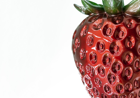 Plastic figurine of strawberry on a white background.の写真素材