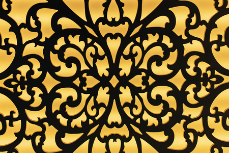 The contour of a metal lattice with an ornament on a yellow background.