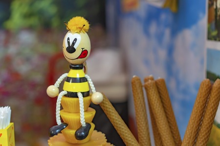 Wooden bee figurine in a honey store.の写真素材
