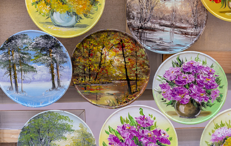 Plates with floral drawings in a street shop.の写真素材