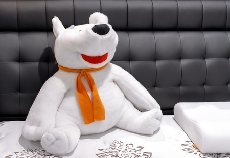 Soft toy polar bear with an orange scarf.の写真素材