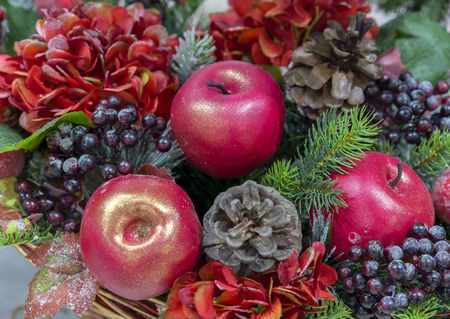 Decorative Christmas composition of apples, berries and pine cones.の写真素材