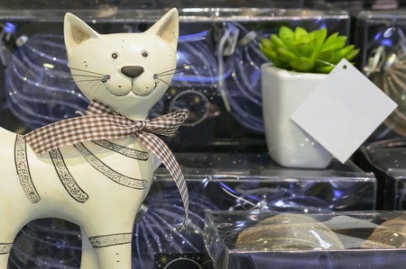Statuette of a smiling cat with a bow in a souvenir shop.の写真素材