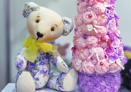 Soft toy teddy bear with a yellow bow.の写真素材