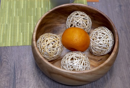 Mandarin with balls in a wooden dish.の写真素材