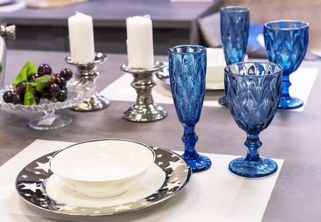 Wineglasses of blue glass in the interior of the dining room.の写真素材