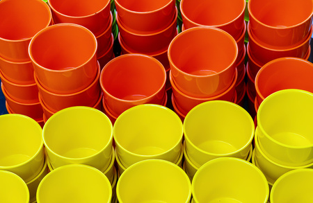 Orange and yellow flower pots on a counter of a flower shop.の写真素材