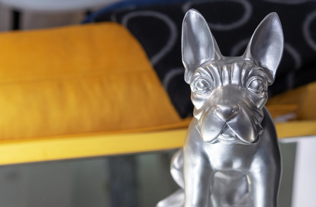 Silver statuette of a dog in the home interior.の写真素材
