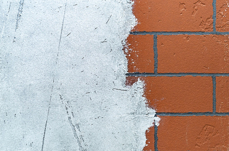 Brick wall with applied white plaster. Background and texture of a brick wall.の写真素材