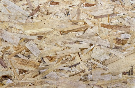 Chipboard background. Rough plywood texture. Plate of compressed sawdust.
