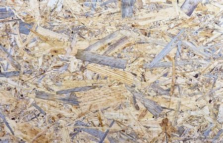 Chipboard background. Rough plywood texture. Plate of compressed sawdust.の写真素材