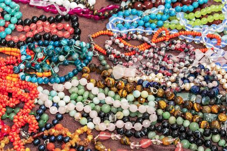 Beads from semiprecious stones. Indian jewelry on the shop counter.の写真素材