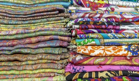 Bright cashmere shawls in the bazaar. Background with oriental shawls.の写真素材