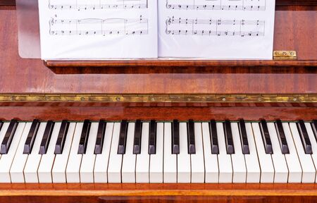 Keyboard on a brown piano. Black and white keys on the keyboard of the old piano.の写真素材