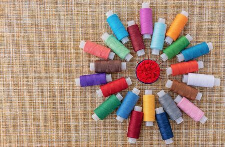 Multicolored sewing threads. Spools of thread for sewing. The concept of sewing accessories.の写真素材