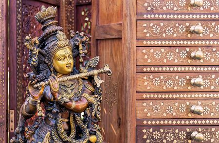 Hindu God Krishna. Statuette of Krishna playing the flute.の写真素材