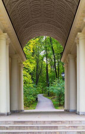 Autumn. Ancient arch with columns in a city autumn park.の写真素材