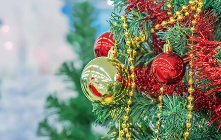 Christmas tree with red and yellow Christmas balls, beads and tinsel.の写真素材