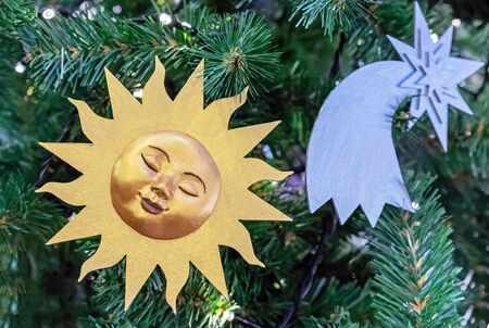 Golden sun and silver star on a christmas tree.の写真素材