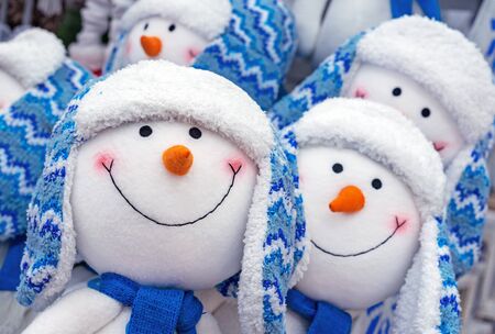 Joyful snowmen. Christmas snowmen in blue hats and scarves.の写真素材