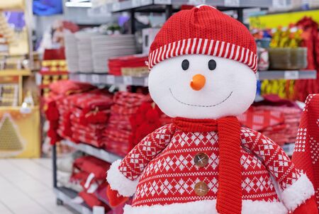 Cristmas soft toy of a snowman in a red sweater, scarf and hat.の写真素材