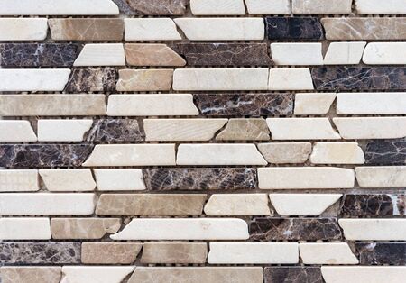 Tiles from pieces of marble and granite. Panel of natural stones.
