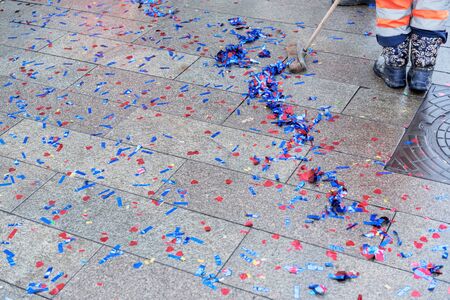 Multi-colored sparkles on the pavement after the holiday clean wipers. The work of the garbage collector.の写真素材