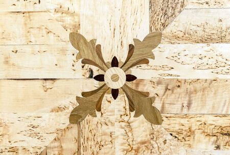 Wooden panel with an ornament. Wooden background for design and decoration.